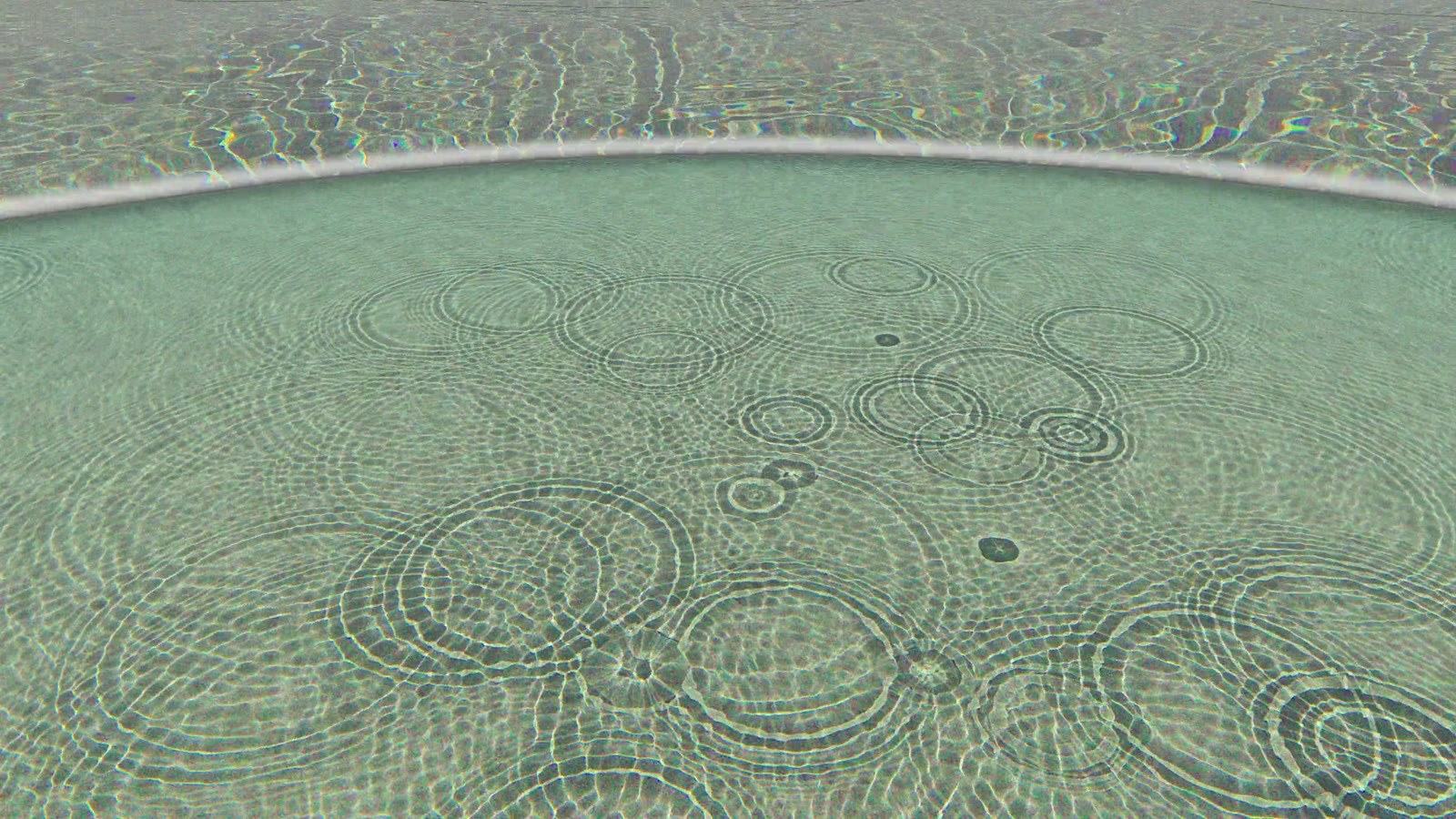 Bright caustic light patterns rippling across a pool floor